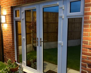 Patio doors in an Essex home with privacy window film installed at night