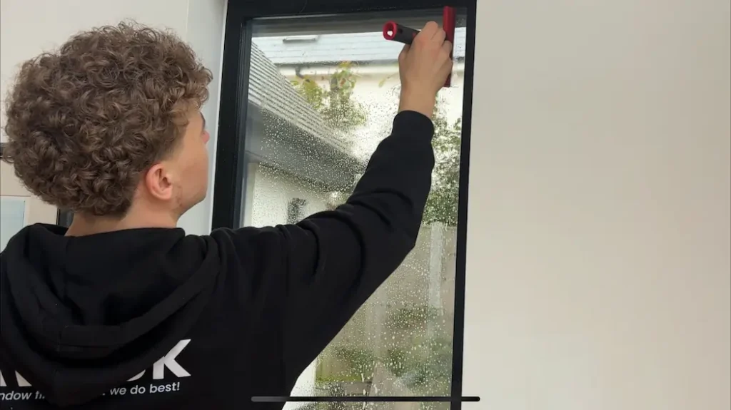 Image of George using a specialist scraper to get rid of dirt and contamination